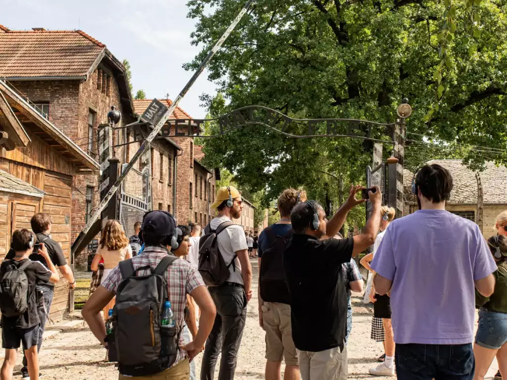 Tourists taking photos of the Auschwitz Gate