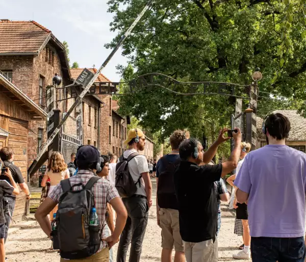 Tourists taking photos of the Auschwitz Gate