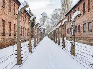 Auschwitz I barbed wire path covered in snow