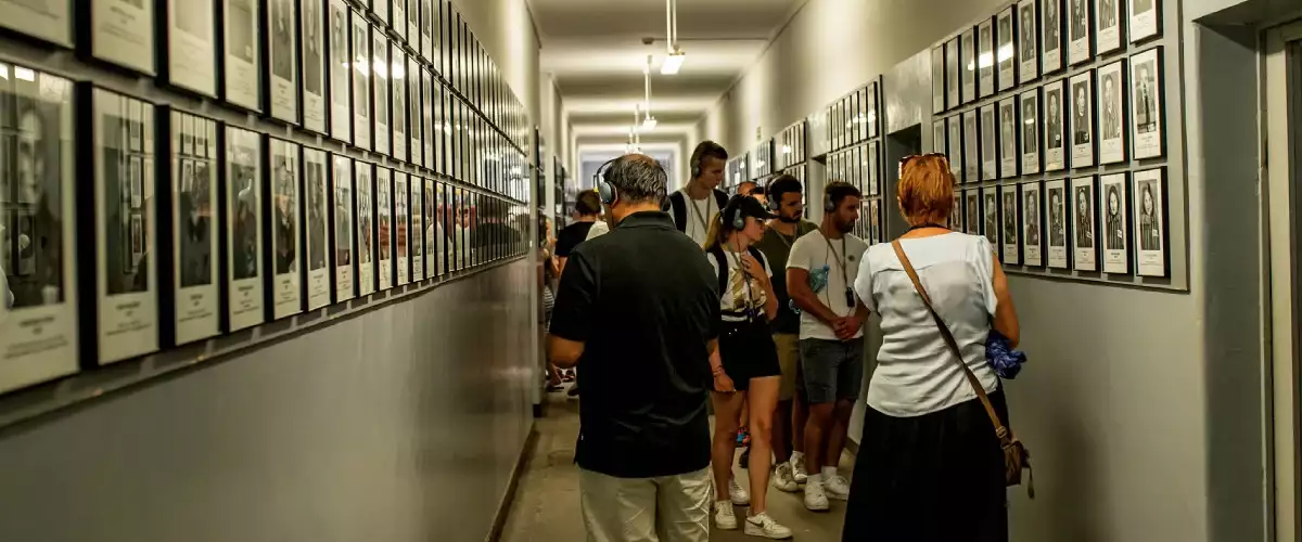 Auschwitz tour - corridor with pictures of the concentration camp victims all over the walls.