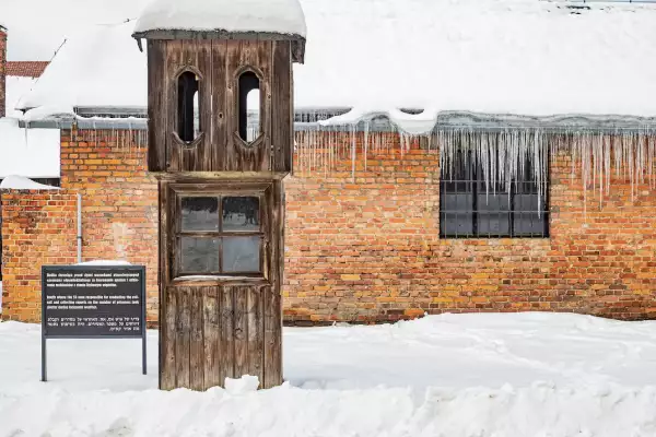 Wooden guard booth in Auschwitz I, covered in snow