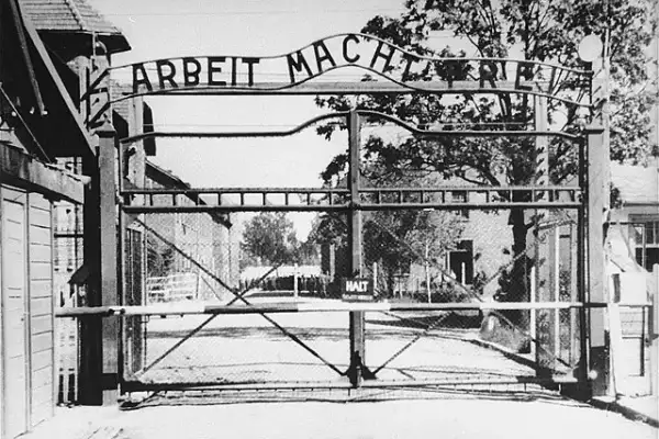 A historical picture of the Arbeit Macht Frei gate in Auschwitz