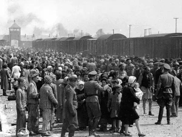 A group of Jews being moved to the Auschwitz concentration camp by SS men